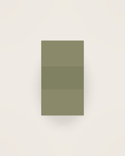 Tela Linen Apron in Olive, front view on a neutral backdrop